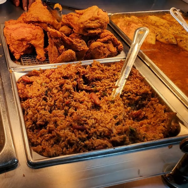 Cajun buffet with trays of fried chicken, jambalaya, and fish in sauce at Tony's Seafood.